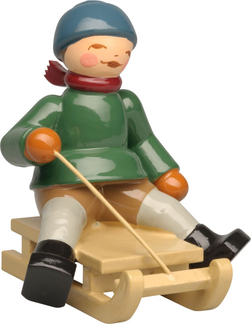 Winterkinder Junge auf Schlitten