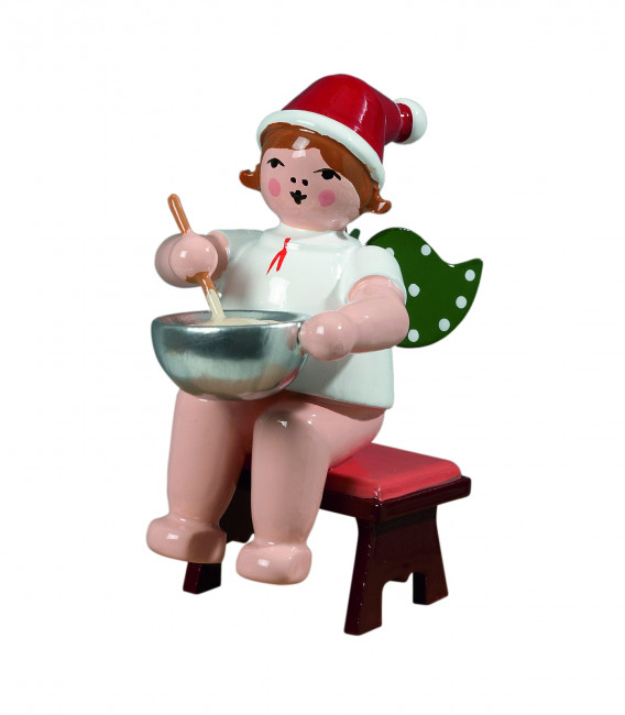 Weihnachtsengel sitzend mit Teigschüssel mit Mütze