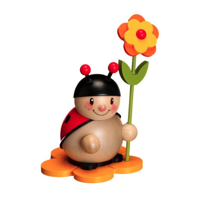 Marienkäfer mit Blüte links